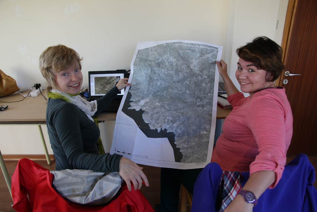 Adela Sobotkova and Petra Janouchova showing the satellite image printout in the Zagora office at Batsi