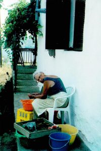 Olwyn Tudor-Jones washing finds in the potshed in Torone in 1990