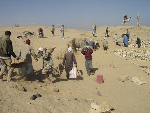 Egyptian workmen clearing away sand in the north-west corner of Teti's pyramid cemetery, early Dynasty 6 (2345-2323 BCE), Saqqara.