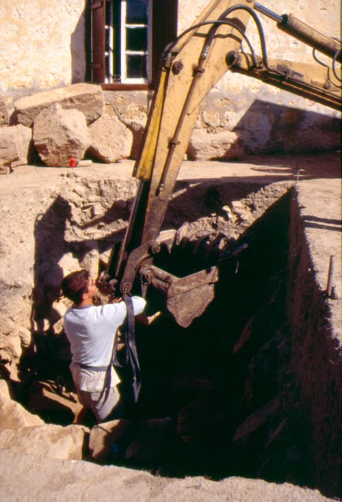 Using a backhoe to remove ashlar blocks