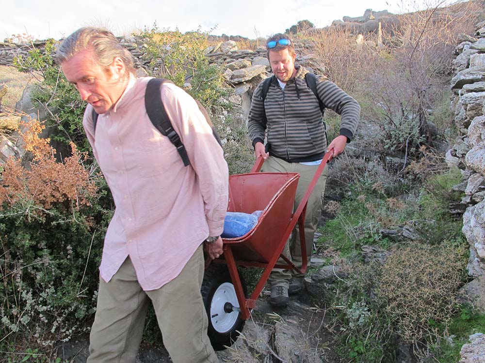 Paul Donnelly and Hugh Thomas carrying a wheelbarrow down to the Zagora site
