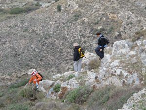 Paul Donnelly, Jane McMahon and Taryn Gooley walking down the steep slope to do a transect survey