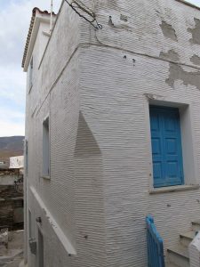 An Andriote corrugated and white-wash rendered wall