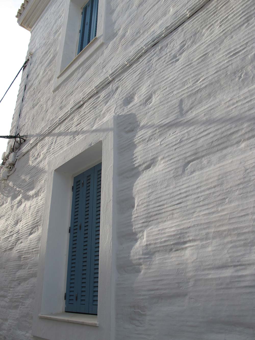 An Andros house with corrugated and white-washed rendering