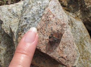 A small fragment of slag, pictured next to my small finger to provide scale