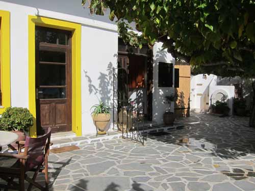 The door to the Kantouni bar is the yellow-framed on at left in this picture. The doorway to our upstairs accommodation is on the right.