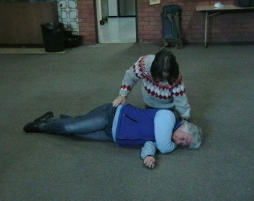 Lesley Beaumont completing the process of putting Meg Miller into the recovery position