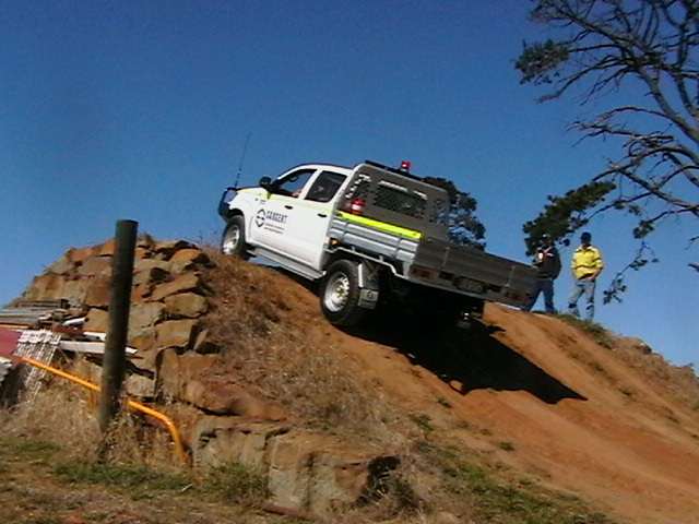 Meg Miller drives up a steep rise in the 4WD