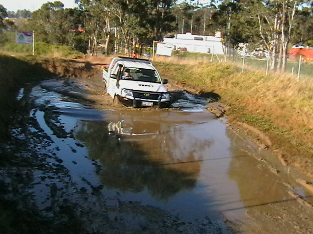 Meg Miller driving a 4WD vehicle through water
