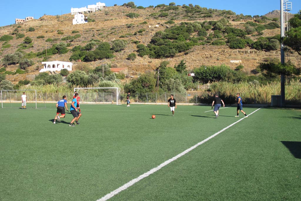 Sami Beaumont-Cankaya is after the ball. You can see one of the high hills of Batsi in the background. There are goats grazing on the hill
