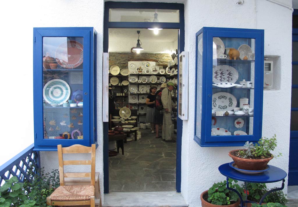 Sophia Melita sherving customers in her shop in Batsi