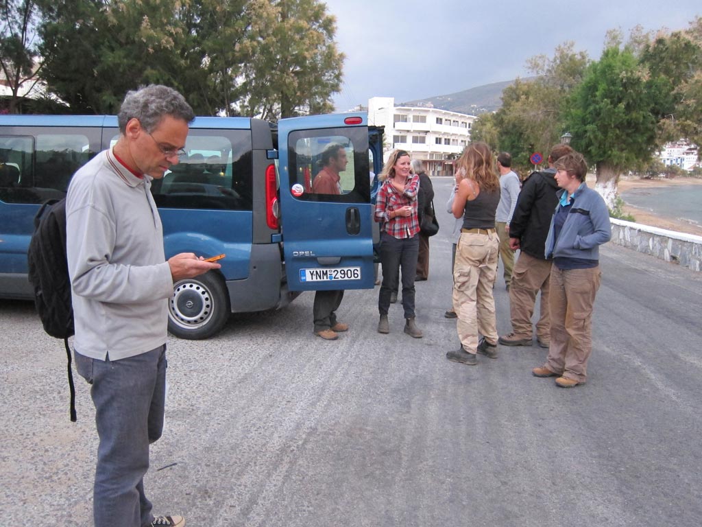Team members waiting by a vehicle outside the Kantouni, in preparation for the drive to Stavropeda