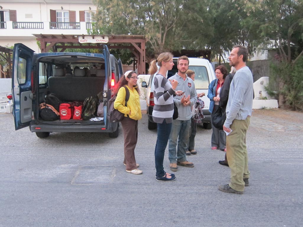Team members waiting by a vehicle outside the Kantouni, in preparation for the drive to Stavropeda