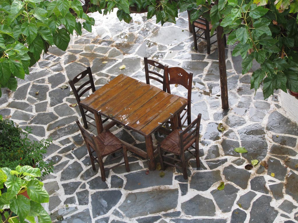 Kantouni courtyard with chairs after a shower