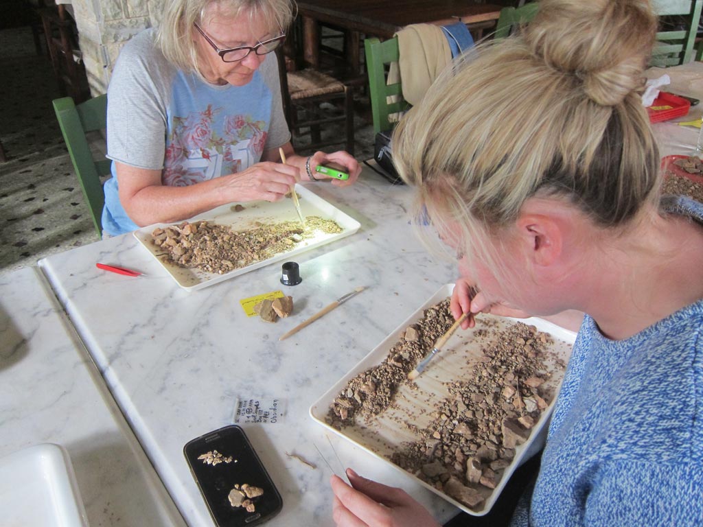 Susan Wrigley and Julia McLachlan looking for organic remains in soil debris