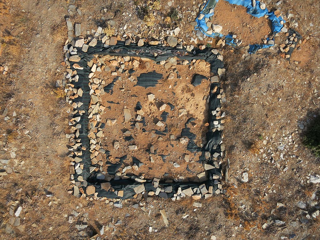 An aerial quadcopter shot of one of the trenches after it has been protected by geotextile and backfilled after the 2014 excavation season