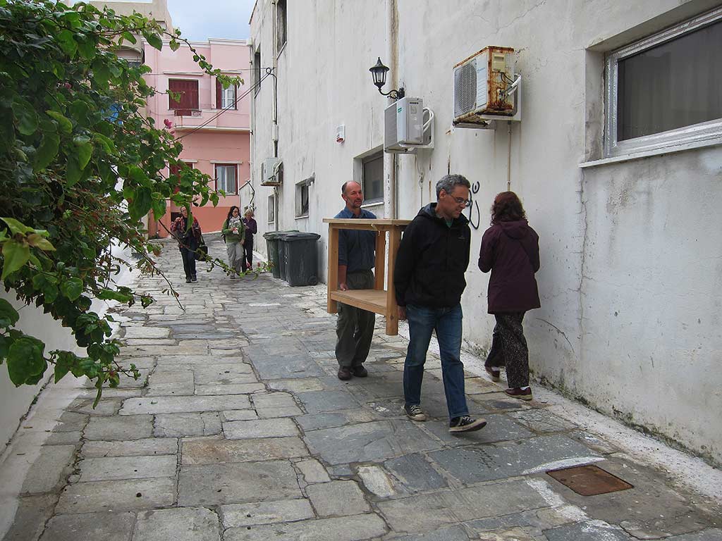Our crew making our way to the Andros Archaeological Museum one morning. In the foreground, Bob Miller and Stavros Paspalas carry a light table into the Museum lab where Bob will take photographs of artefacts. This table was made on the island to Bob's specifications